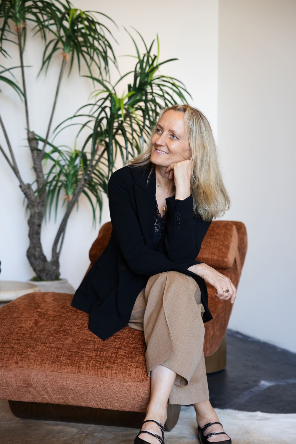 Diana Braun reading on an orange chaise